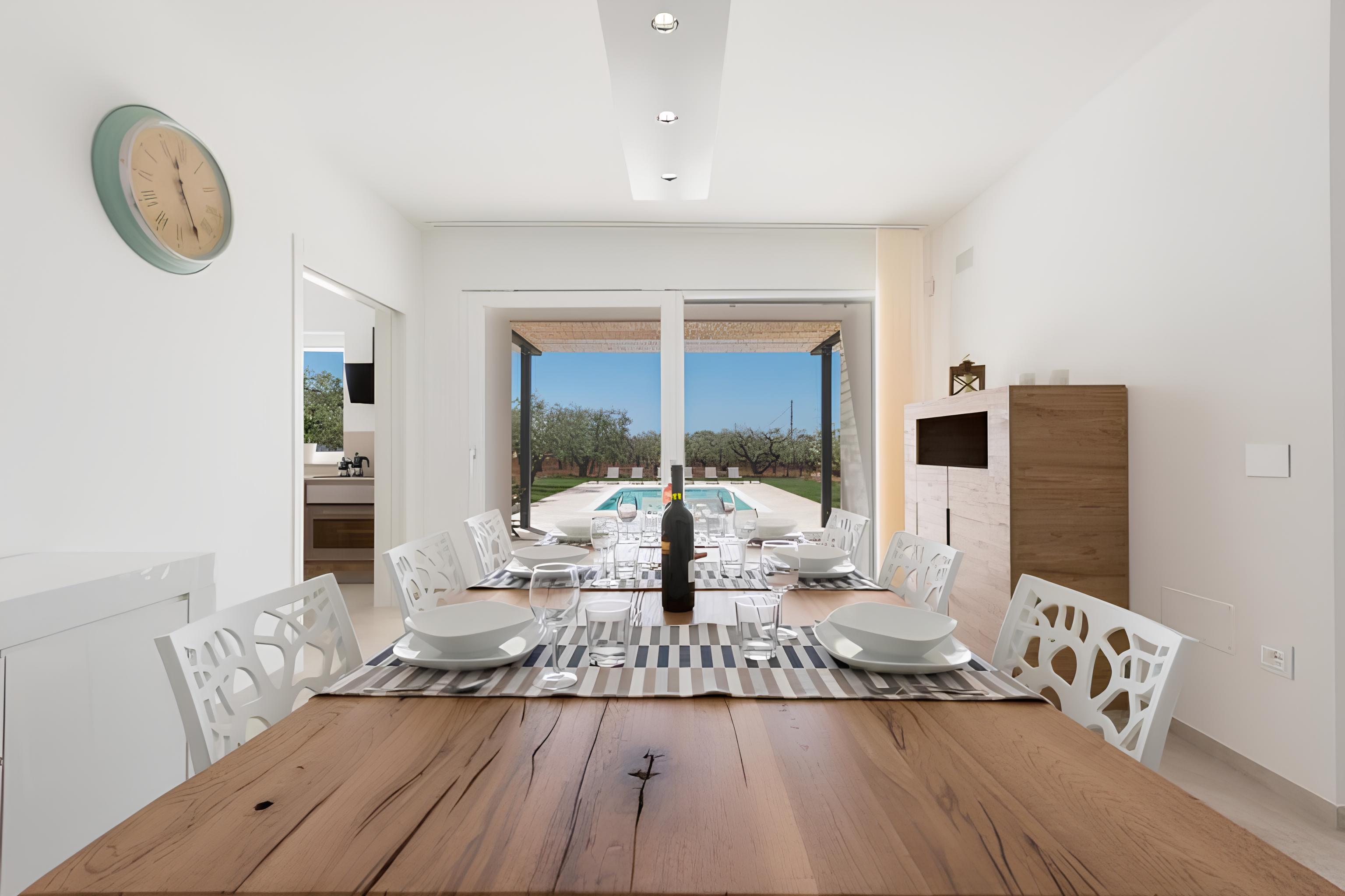 Dining room opening toward the pool and olive grove